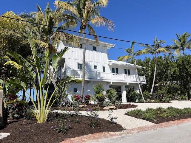 view of front of home featuring board and batten siding and a balcony