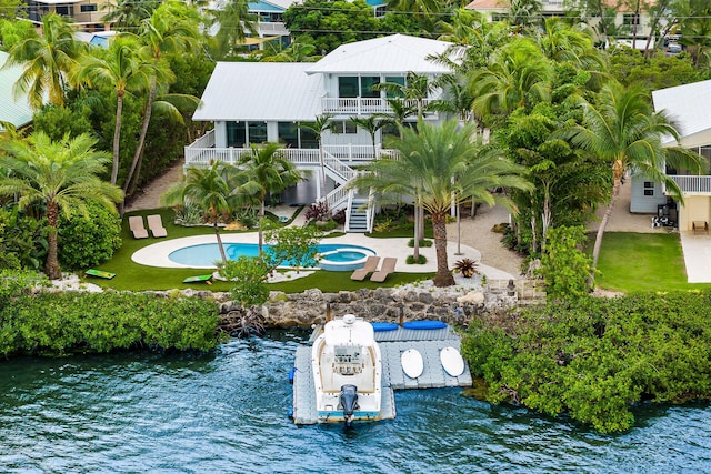 birds eye view of property with a water view