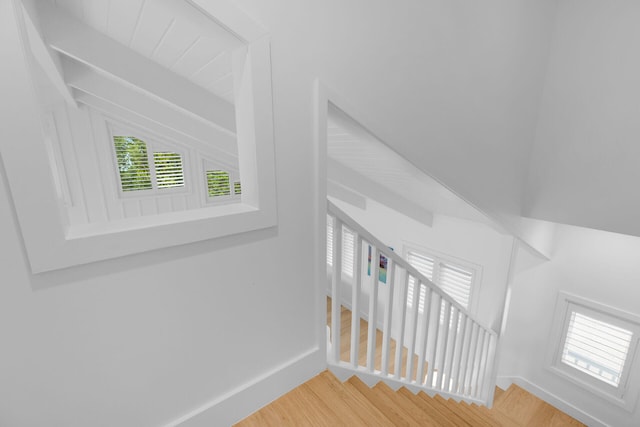 stairway featuring wood finished floors and baseboards