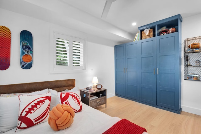 bedroom with light wood-style flooring, baseboards, and recessed lighting