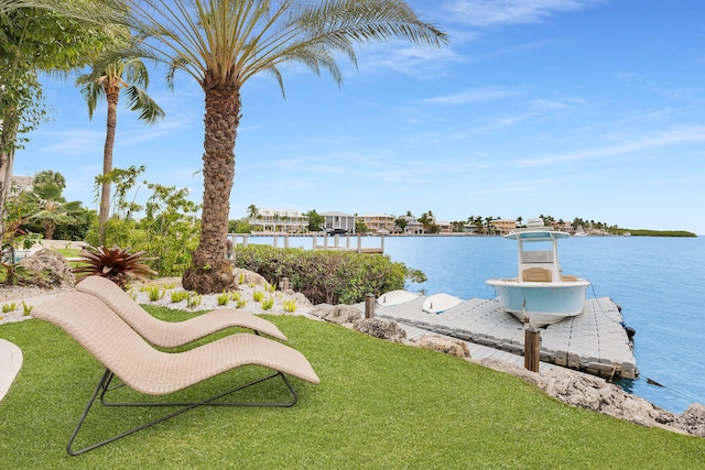 view of yard with a boat dock and a water view