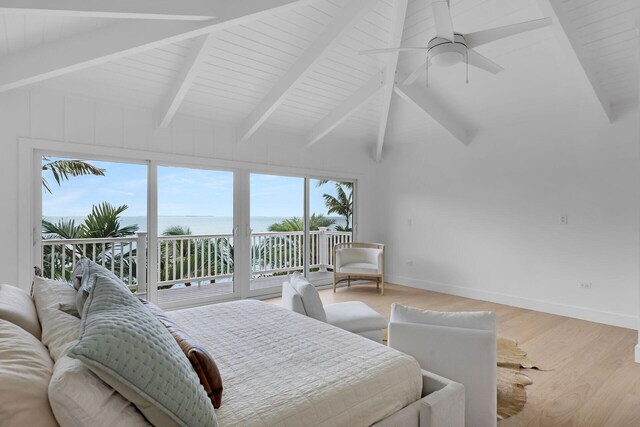 bedroom featuring ceiling fan, vaulted ceiling with beams, a water view, light hardwood / wood-style floors, and access to outside