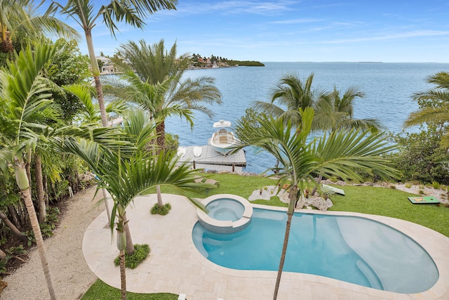 view of swimming pool featuring an in ground hot tub and a water view