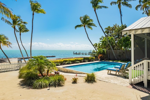 view of swimming pool featuring a water view and a patio