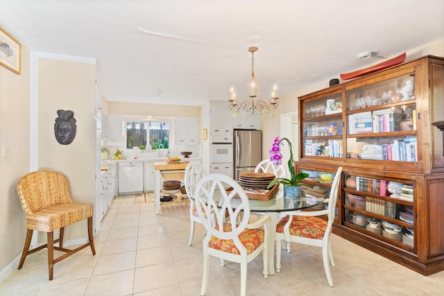 tiled dining space with an inviting chandelier and sink