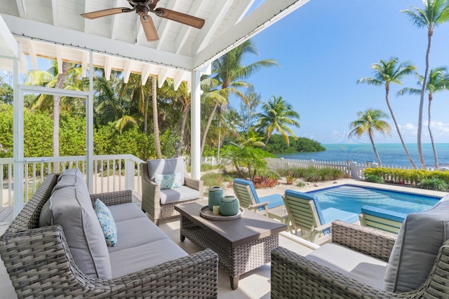 exterior space featuring lofted ceiling, a wealth of natural light, ceiling fan, and a water view