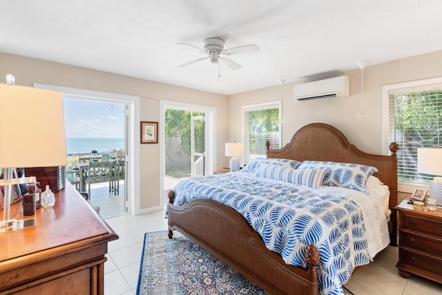 tiled bedroom with multiple windows, a wall mounted air conditioner, access to outside, and a water view