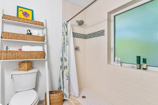 bathroom with a shower with curtain and toilet