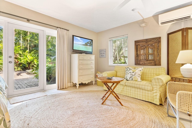 sitting room with tile patterned flooring, a healthy amount of sunlight, and a wall unit AC