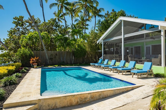 view of pool featuring a patio area and glass enclosure