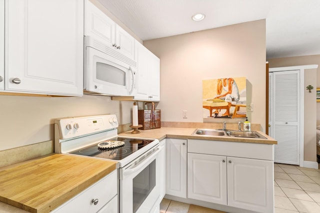 kitchen featuring white cabinetry, sink, light tile patterned floors, kitchen peninsula, and white appliances