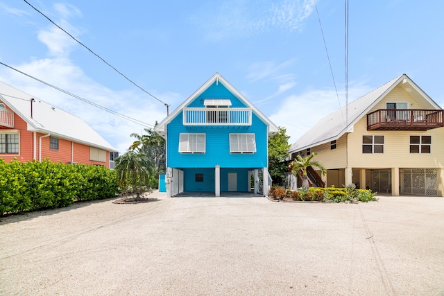 view of front of property featuring a carport and a balcony