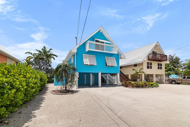 coastal home featuring a carport and a balcony