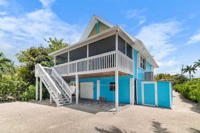 back of property with a sunroom