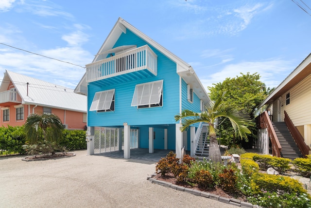 beach home featuring a carport and a balcony