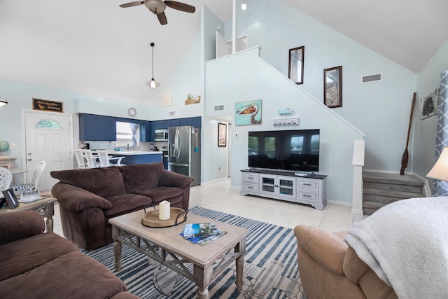 tiled living room with ceiling fan and vaulted ceiling