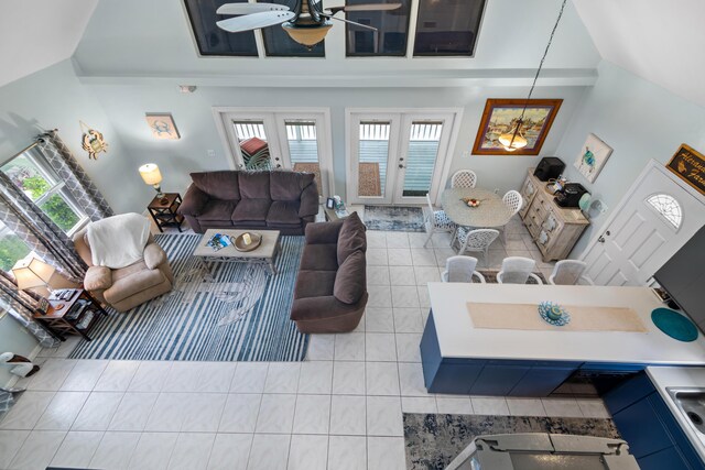 living room with light tile patterned flooring, vaulted ceiling, a wealth of natural light, and french doors