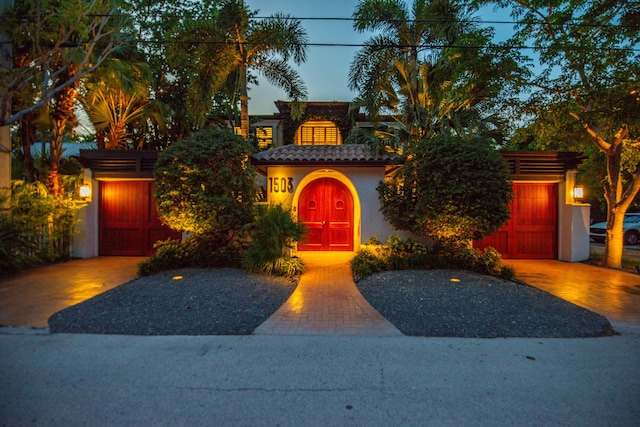 mediterranean / spanish home with a garage