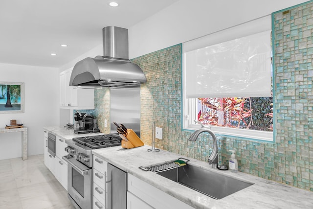 kitchen featuring stainless steel appliances, white cabinetry, sink, and island range hood