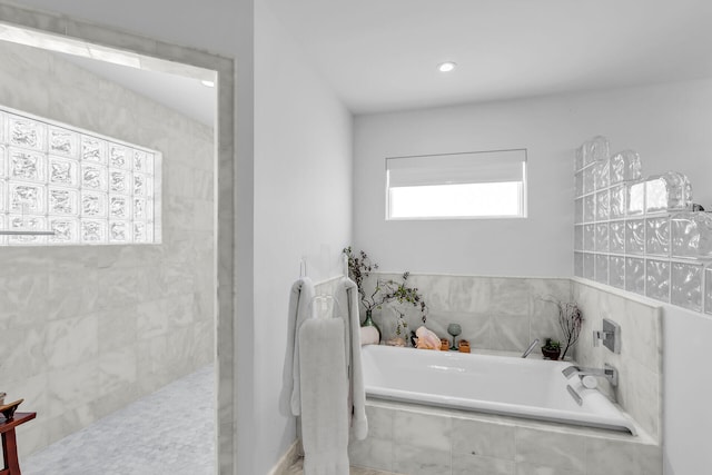 bathroom with tiled tub