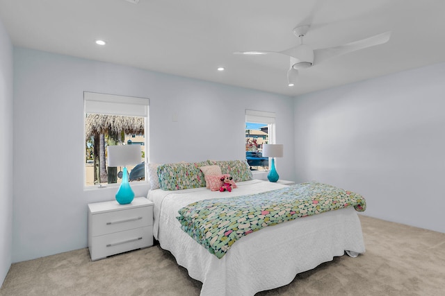 bedroom featuring light carpet and ceiling fan