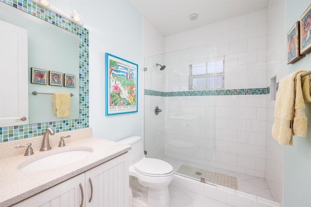 full bath with vanity, toilet, and tiled shower