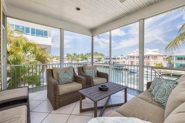sunroom / solarium featuring a water view, outdoor lounge area, and plenty of natural light
