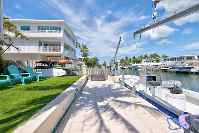 dock area featuring a water view and a lawn