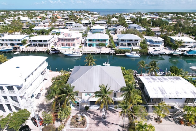 bird's eye view featuring a water view and a residential view