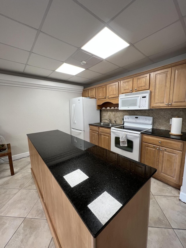 kitchen with tasteful backsplash, white appliances, dark stone countertops, and light tile patterned flooring