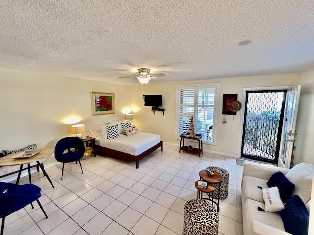 tiled bedroom featuring access to exterior, a textured ceiling, and ceiling fan