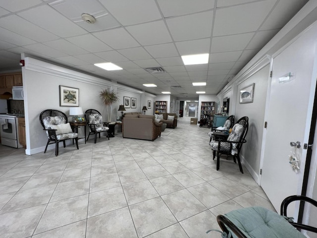 tiled living room featuring a paneled ceiling