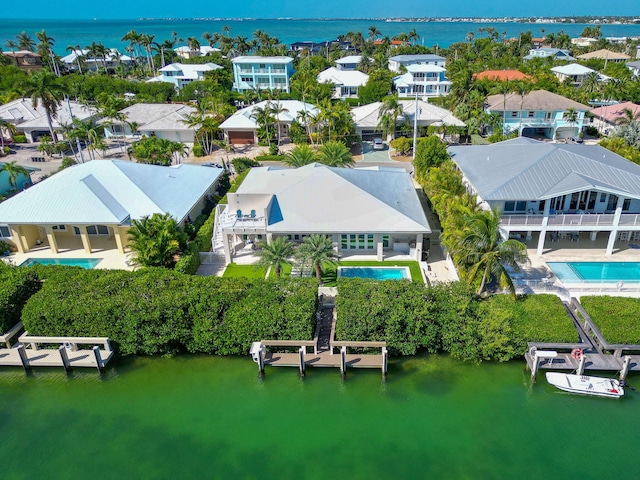 drone / aerial view featuring a residential view and a water view