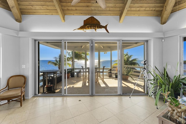 doorway to outside featuring beamed ceiling, a water view, wooden ceiling, and light tile patterned floors
