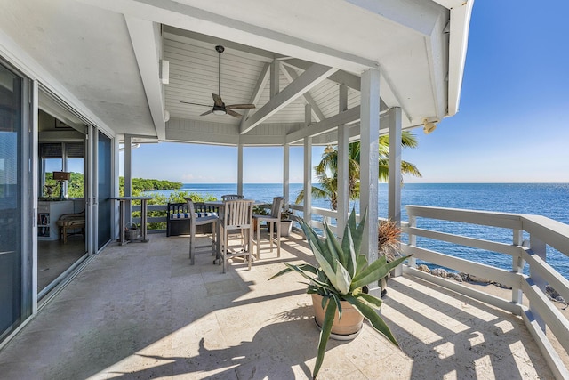 view of patio with a ceiling fan and a water view