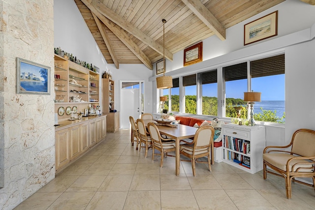 dining space with wooden ceiling, high vaulted ceiling, plenty of natural light, light tile patterned floors, and beamed ceiling