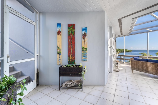 sunroom / solarium featuring a water view and plenty of natural light