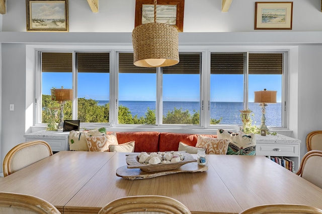 dining room with plenty of natural light and a water view