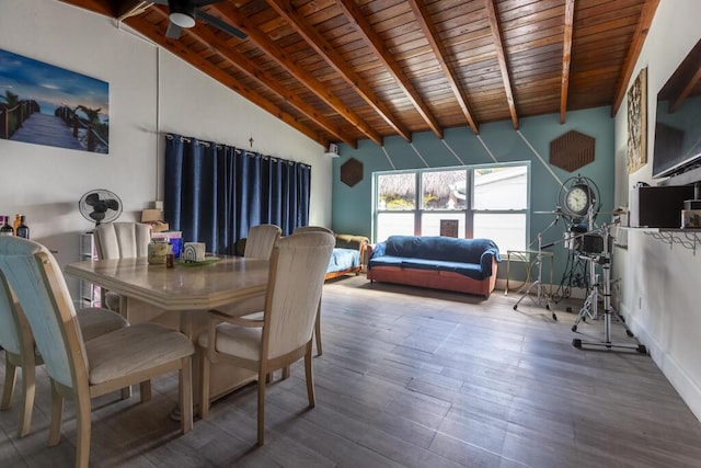 dining space featuring hardwood / wood-style flooring, vaulted ceiling with beams, and wooden ceiling