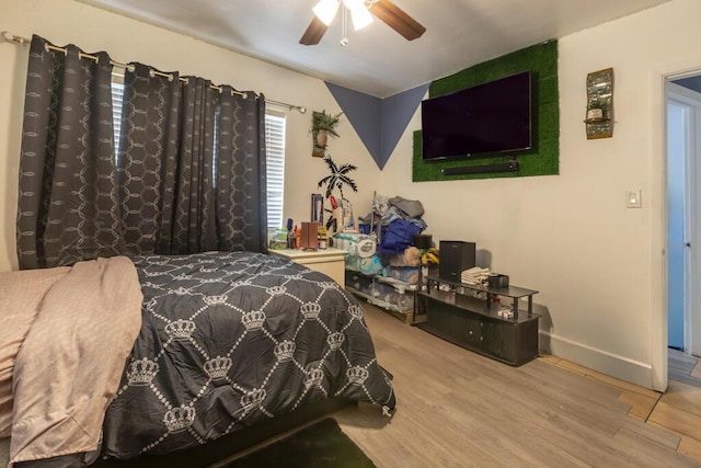 bedroom with ceiling fan and light hardwood / wood-style floors