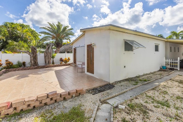 view of property exterior with a patio area