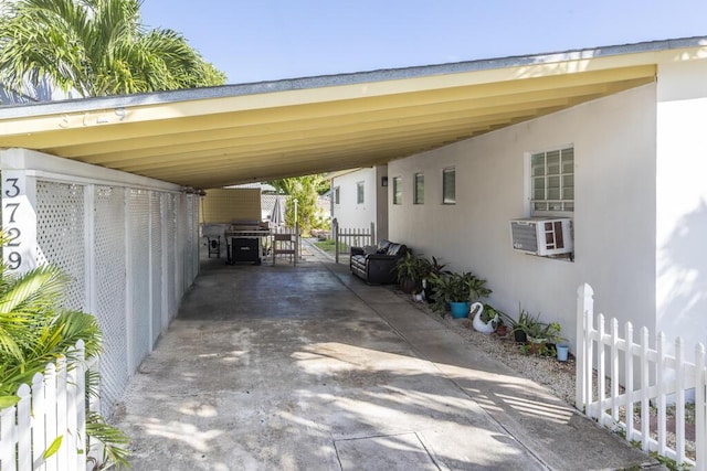 view of vehicle parking featuring cooling unit and a carport