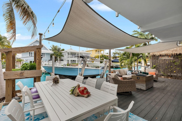 deck with a water view and an outdoor hangout area