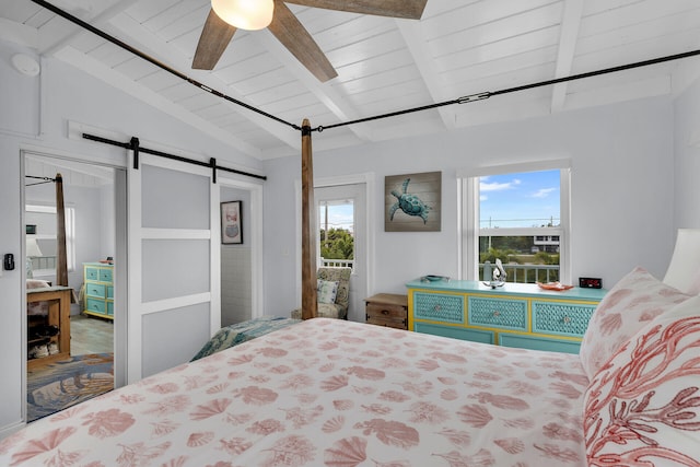 bedroom featuring wood ceiling, ceiling fan, a barn door, and lofted ceiling with beams