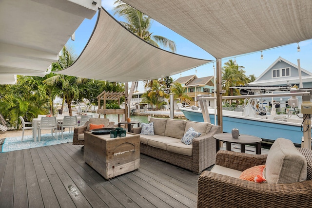 deck featuring a water view, an outdoor living space, and a pergola