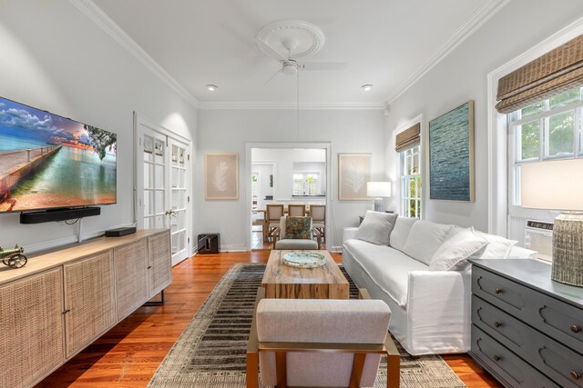 living room featuring hardwood / wood-style flooring and crown molding