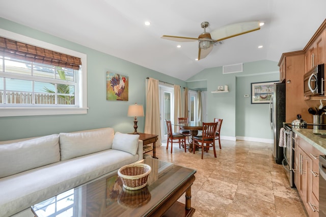 living room featuring vaulted ceiling and ceiling fan