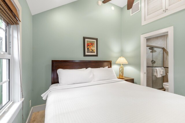 bedroom featuring multiple windows and connected bathroom