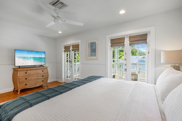 bedroom featuring french doors, ceiling fan, wood-type flooring, and access to exterior