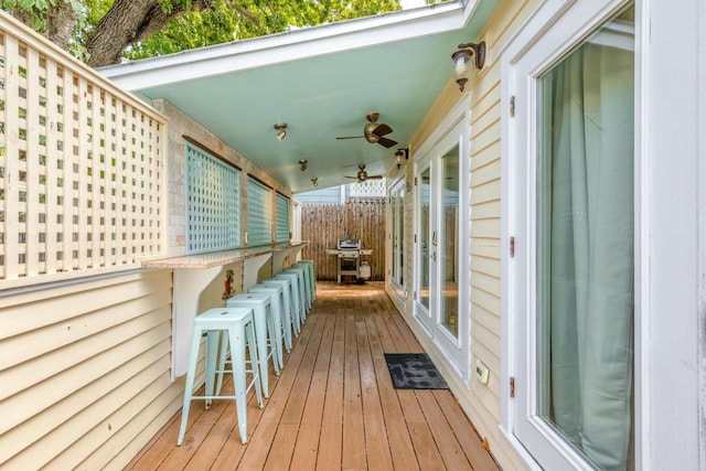 deck featuring a bar and ceiling fan